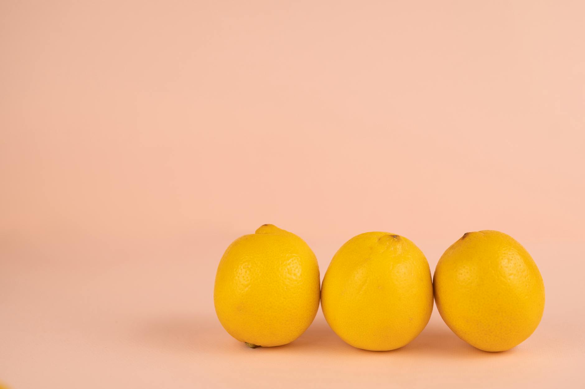 Bright ripe lemons on a soft pastel background